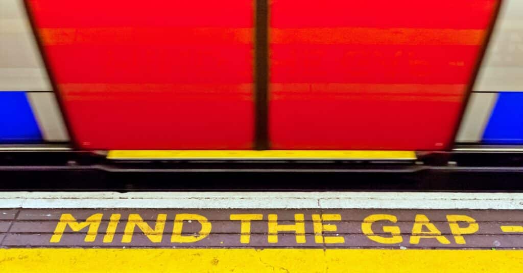 Mind the Gap sign at London train station reminding employers about labor law posting