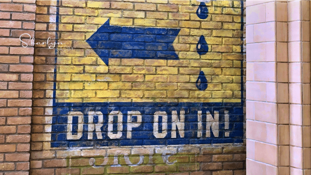 drop on in sign welcoming customers and employees back to the workplace