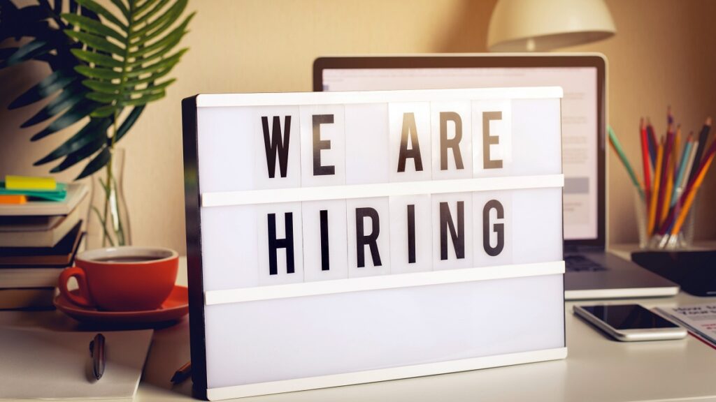 We are recruiting and hiring text on light box on desk office