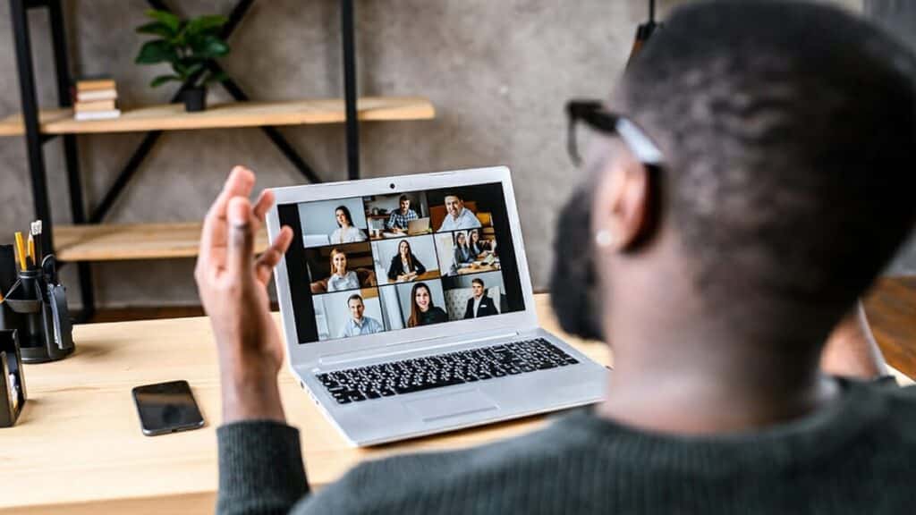 remote work showing manager video conferencing with employee team