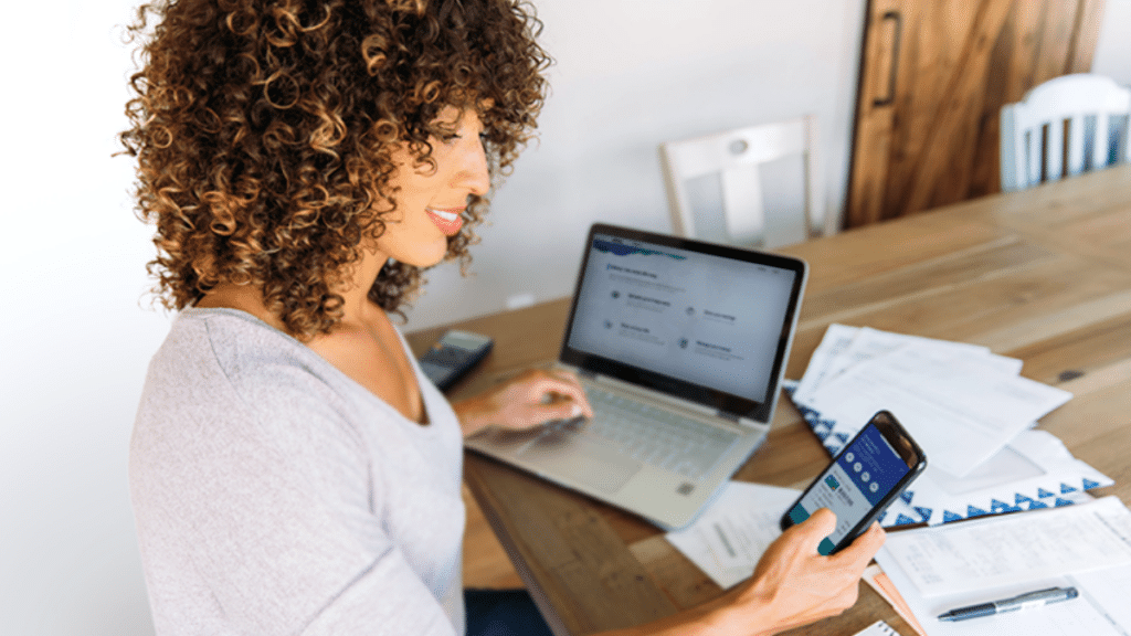 employee working at a desk thinking about financial wellbeing