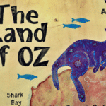 wall sign indicating the Land of Oz for remote work compensation