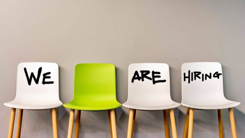four chairs displaying the words we are hiring to discuss recruiting