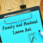 clipboard with Family and Medical Leave Act showing HR Law strategy