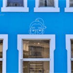 wall art of people faces over windows like looking into insurance surcharges