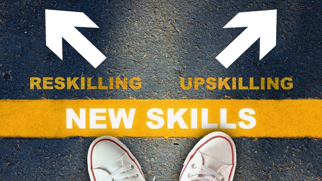 New skills development concept and changing skill demand idea. New skills written on yellow line with reskilling and upskilling with white arrow on asphalt road