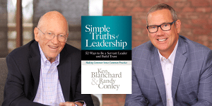 Dr. Ken Blanchard and Randy Conley with their book cover Simple Truths Leadership