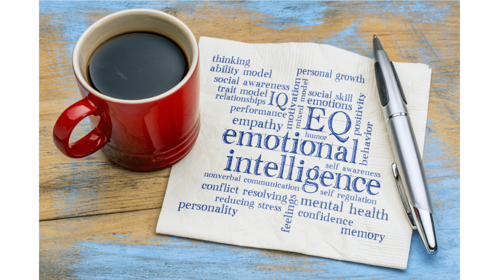 emotional intelligence on napkin next to coffee mug and pen