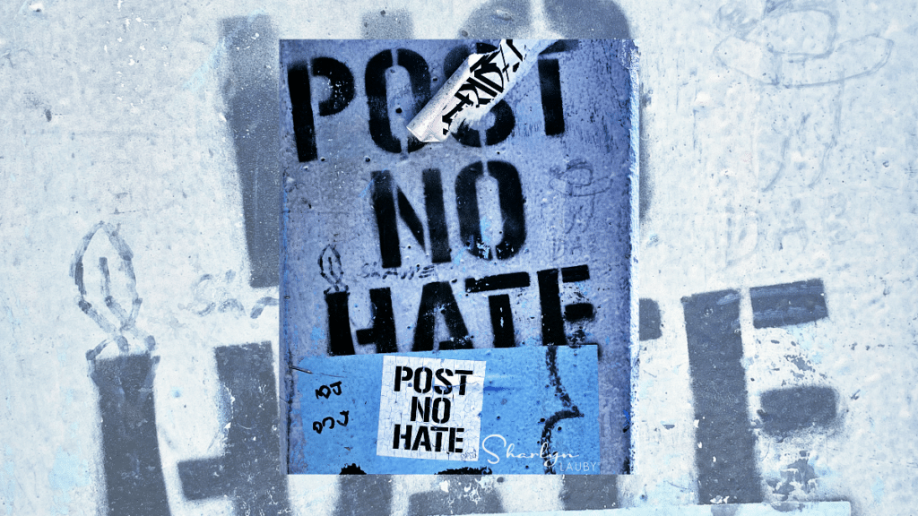post no hate sign and wall art about conflict management