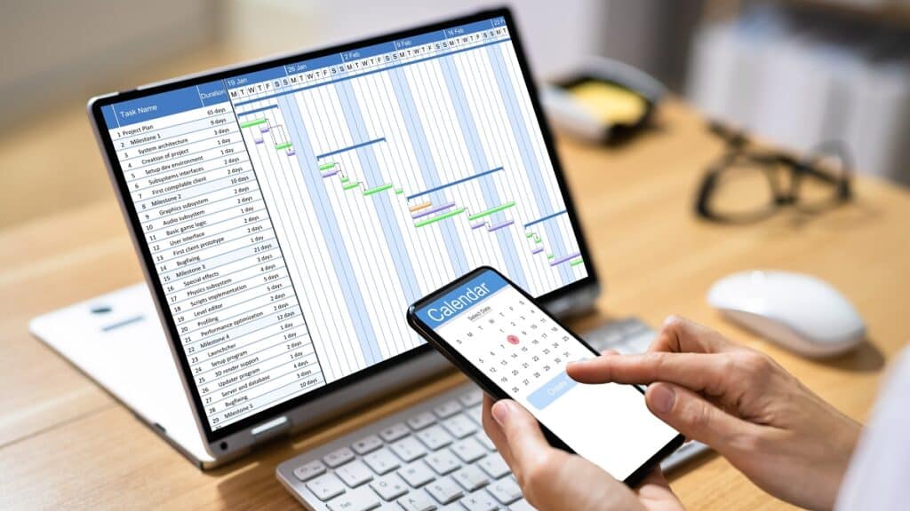 Scheduling software on a laptop and smartphone to manage workforce