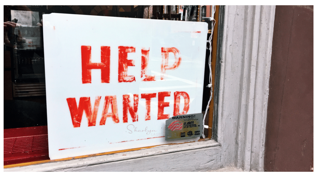 old help wanted sign implying employment references in a business window