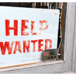 old help wanted sign implying employment references in a business window