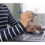 team members working on laptop as part of a team
