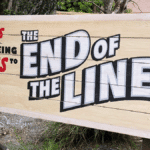 theme park sign indicating the end of the line for an employee