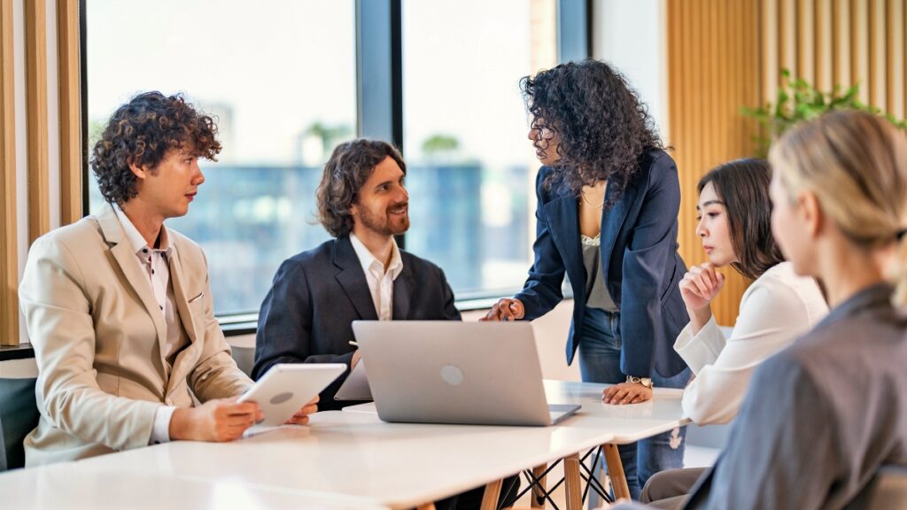 image of managers talking in a meeting room discussing company policy