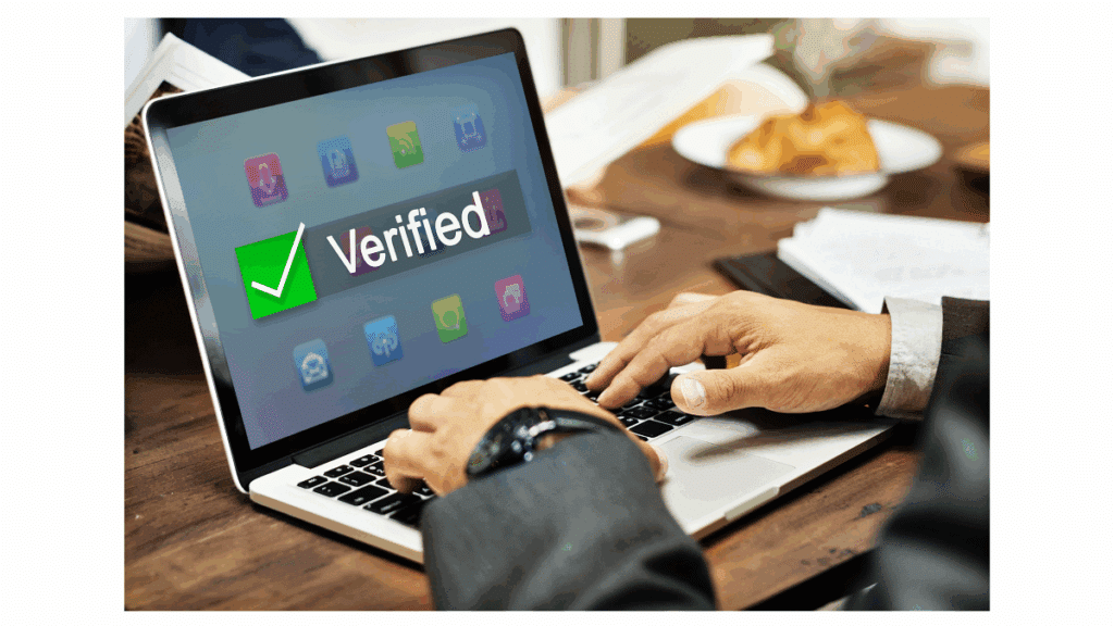 workplace office laptop on desk showing verified through E-Verify