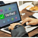 workplace office laptop on desk showing verified through E-Verify