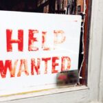 help wanted sign in window showing need for job search activity